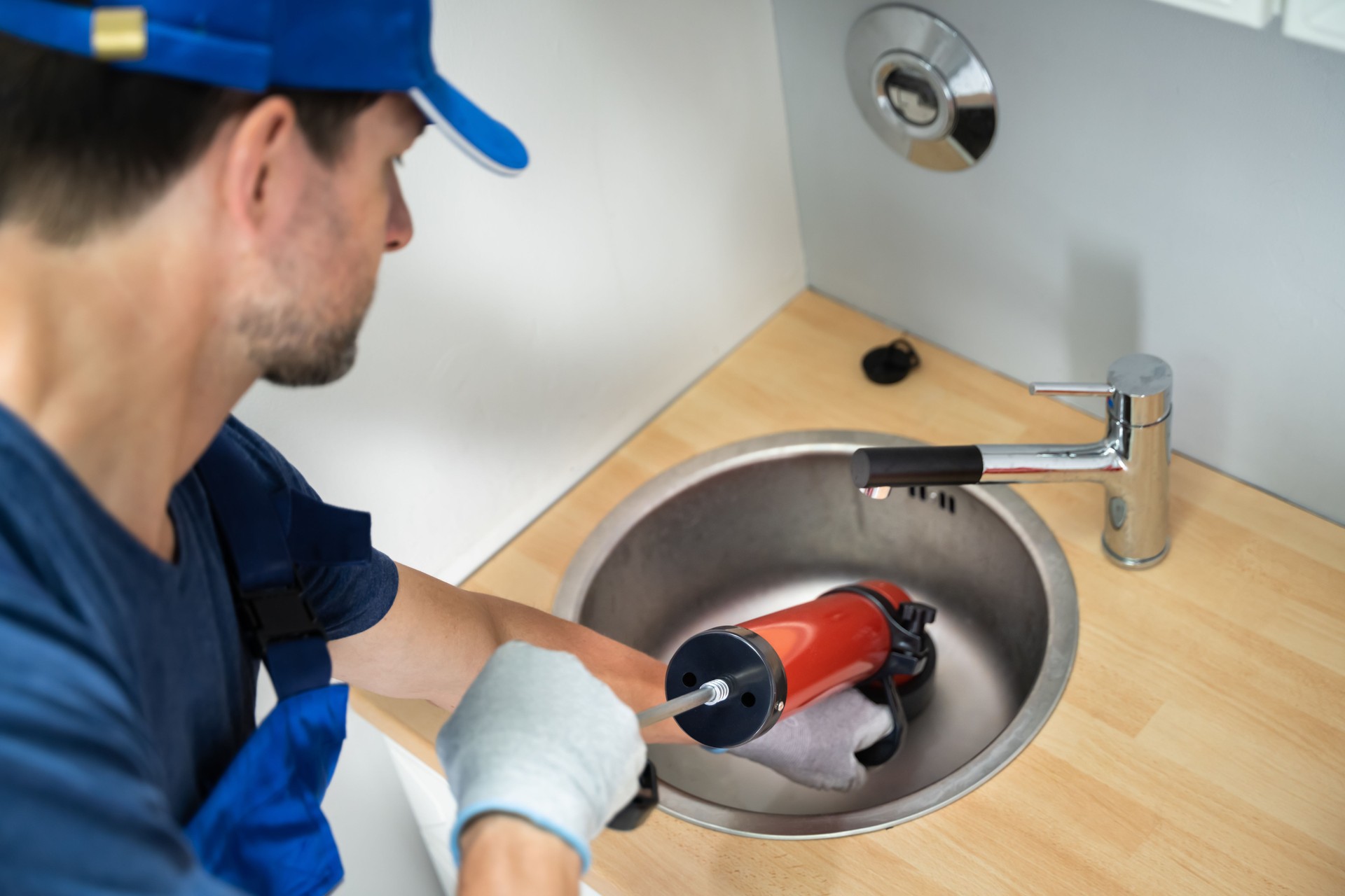 Plumber Cleaning Drain And Sink